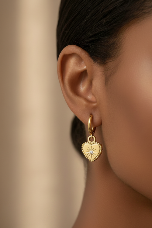 Trove Colombo gold heart drop earrings with a central star-set diamond