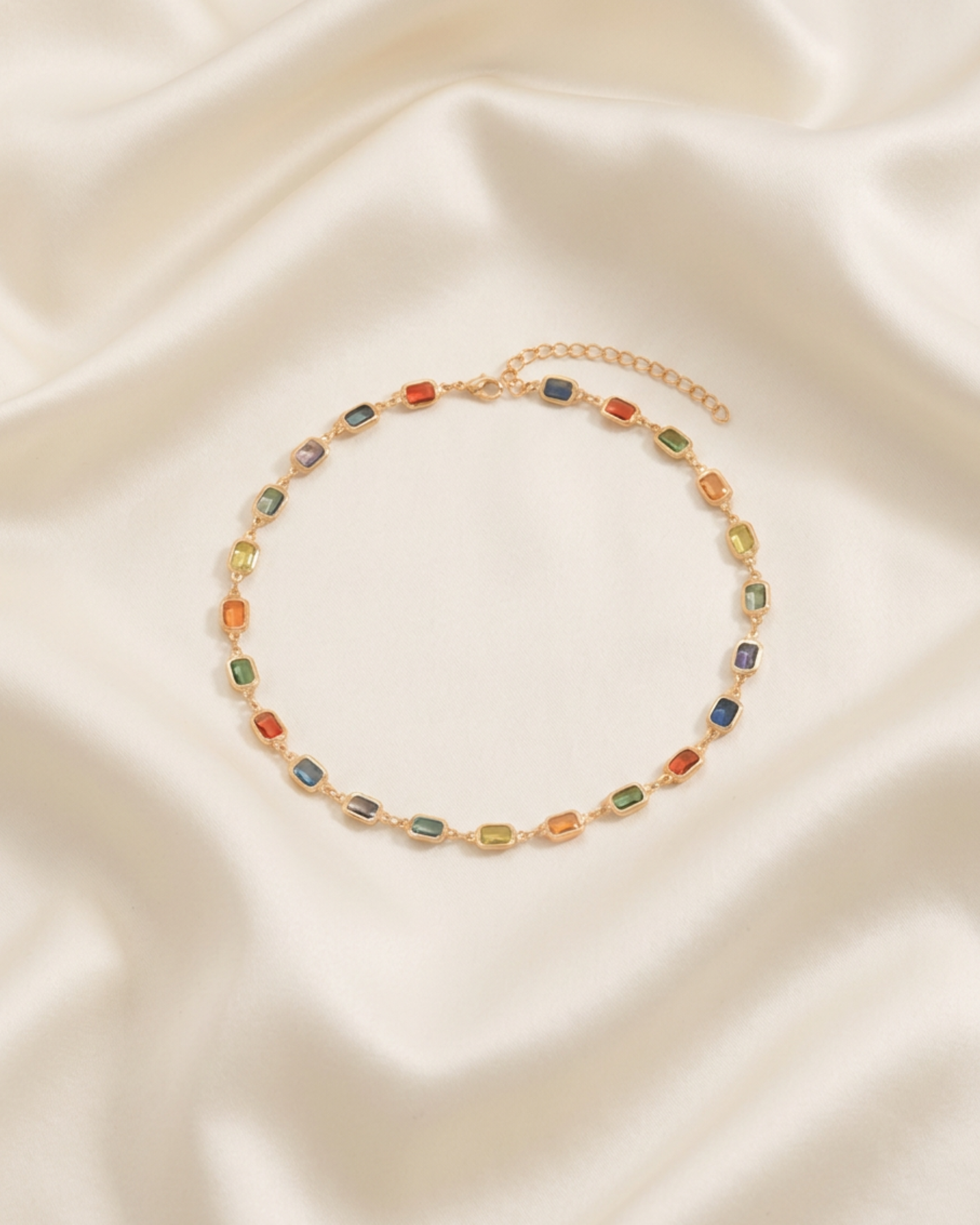 Trove Colombo Acacia necklace featuring multi-colored synthetic ruby-style stones set in polished gold-tone stainless steel.