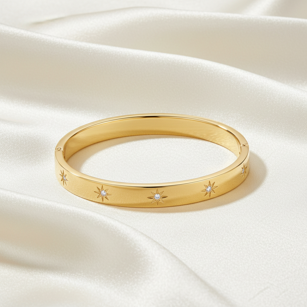 Trove Colombo Venus 18K gold-plated stainless steel bangle featuring star-shaped cubic zirconia