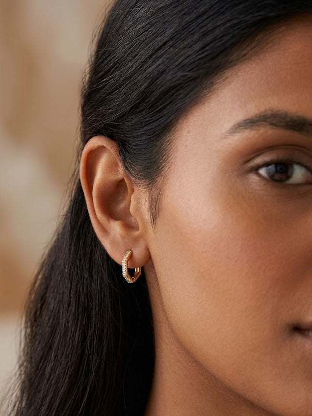 Trove Colombo Alina Zirconia gold hoop earrings with delicate crystal embellishments.