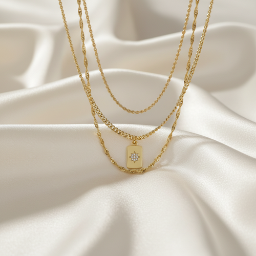 Trove Colombo Amelia 3-piece gold-tone stainless steel layered necklace with a star-engraved rectangular pendant.