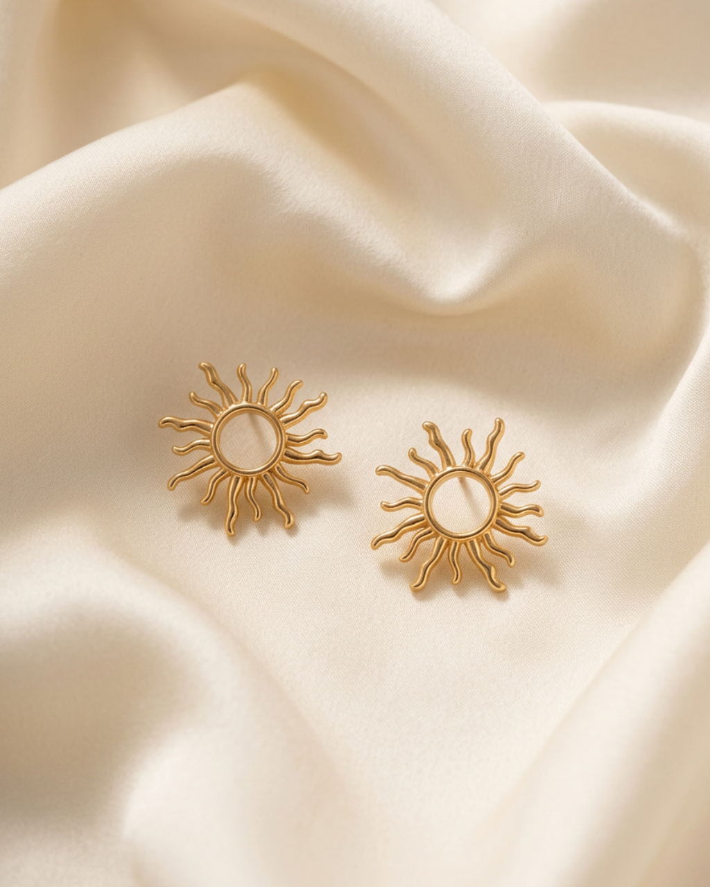 Trove Colombo Delphine 14K gold-plated sun-shaped stud earrings resting