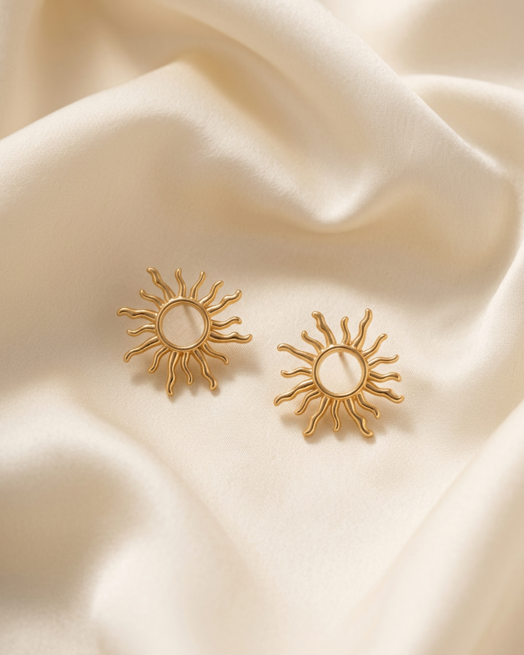 Trove Colombo Delphine 14K gold-plated sun-shaped stud earrings resting