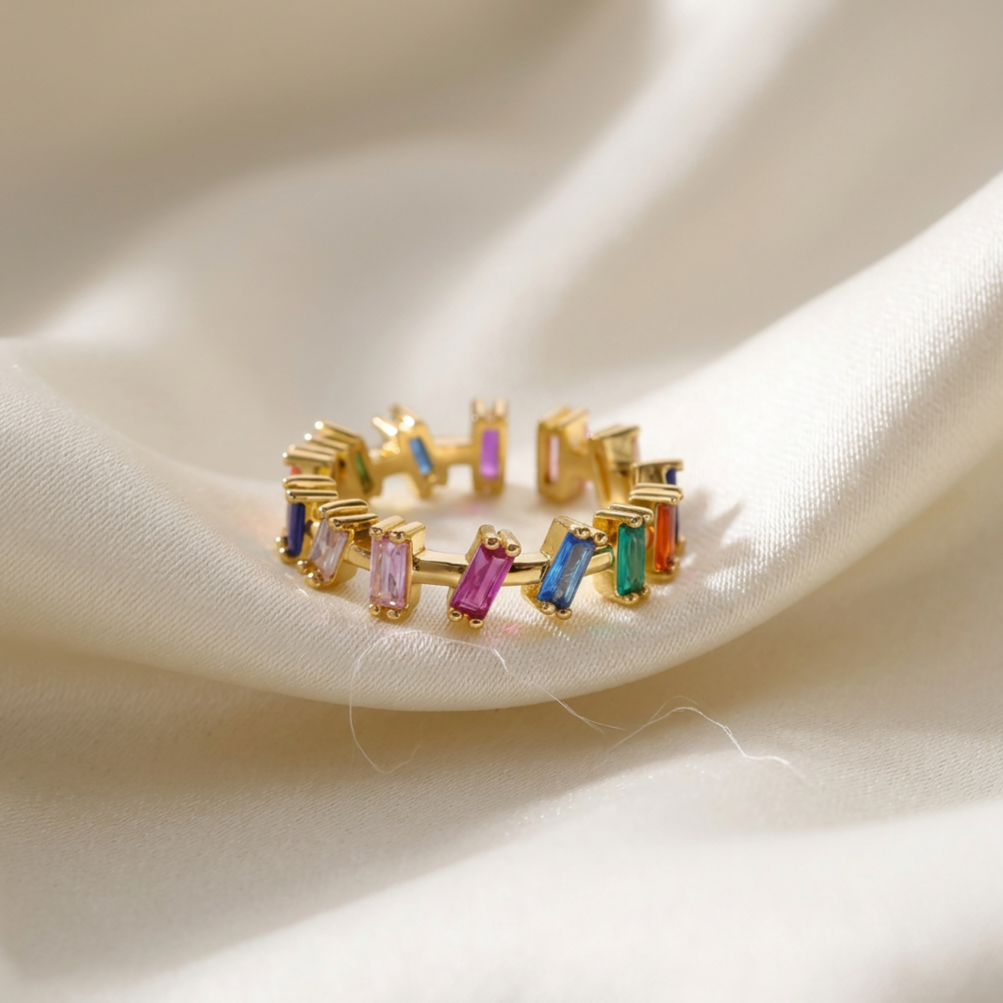 Trove Colombo Lovella 18K gold-plated ring featuring multi-colored baguette cubic zirconia stones in a boho style.