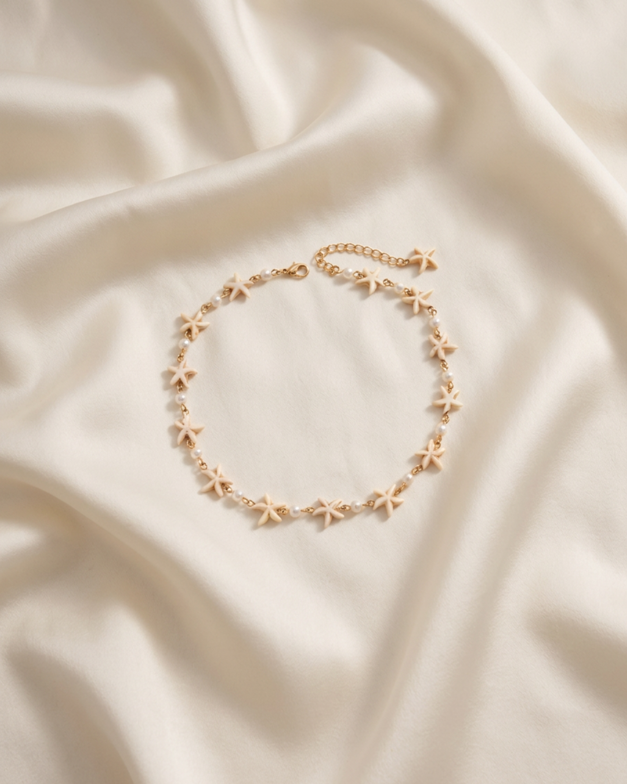Trove Colombo Maristella necklace featuring cream starfish charms and small pearls on a KC gold-plated chain.