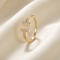 Trove Colombo Octavia gold-tone copper ring with T-shaped ends inlaid with sparkling synthetic cubic zirconia stones.