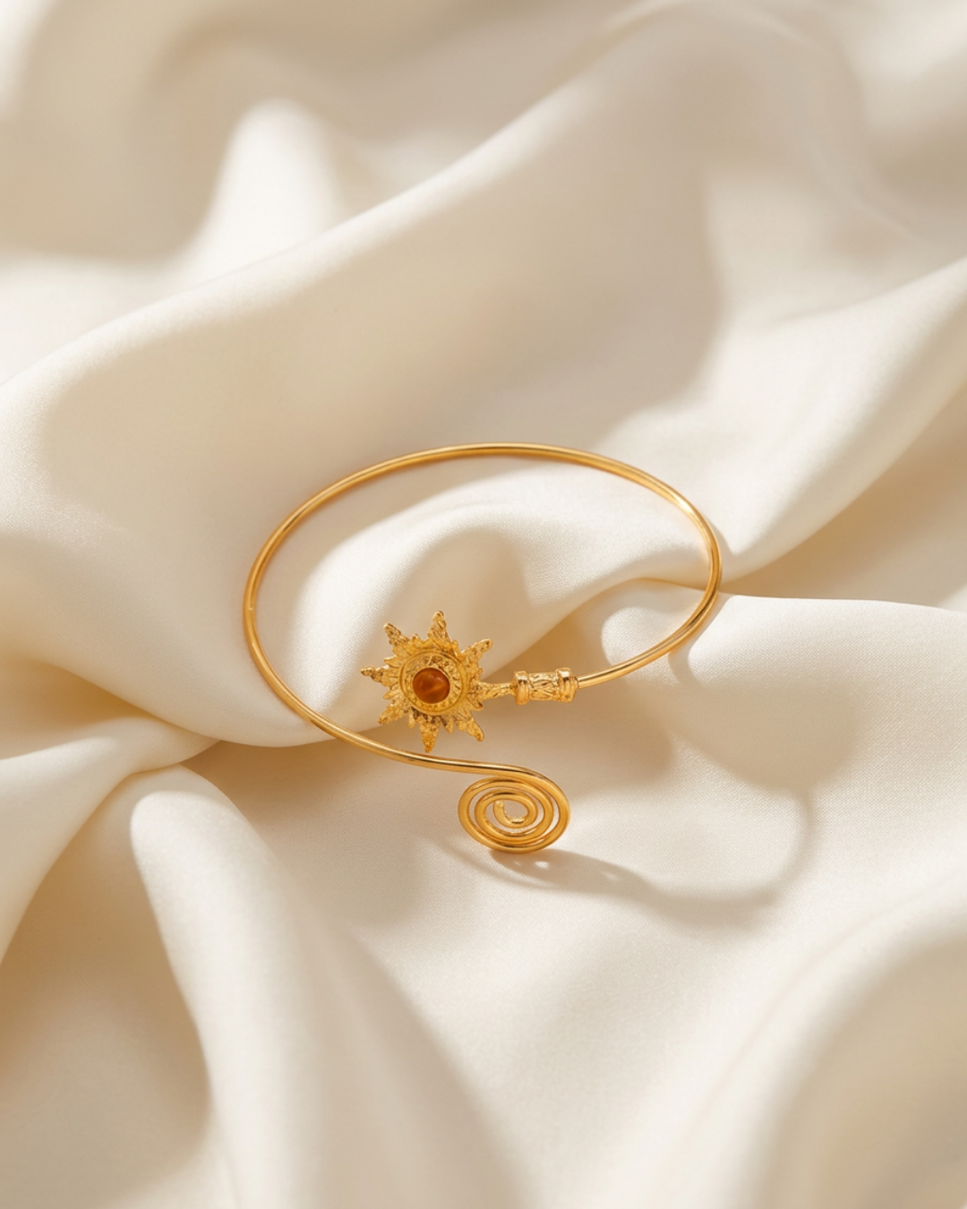 Trove Colombo Soleil gold-tone Soleil cuff bracelet featuring a sun motif and spiral end
