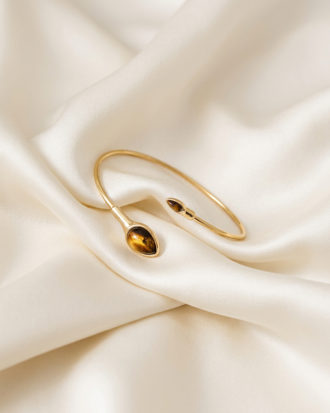 Trove Colombo Tiger Eye gold-tone alloy cuff bracelet featuring two teardrop-shaped tiger eye stone