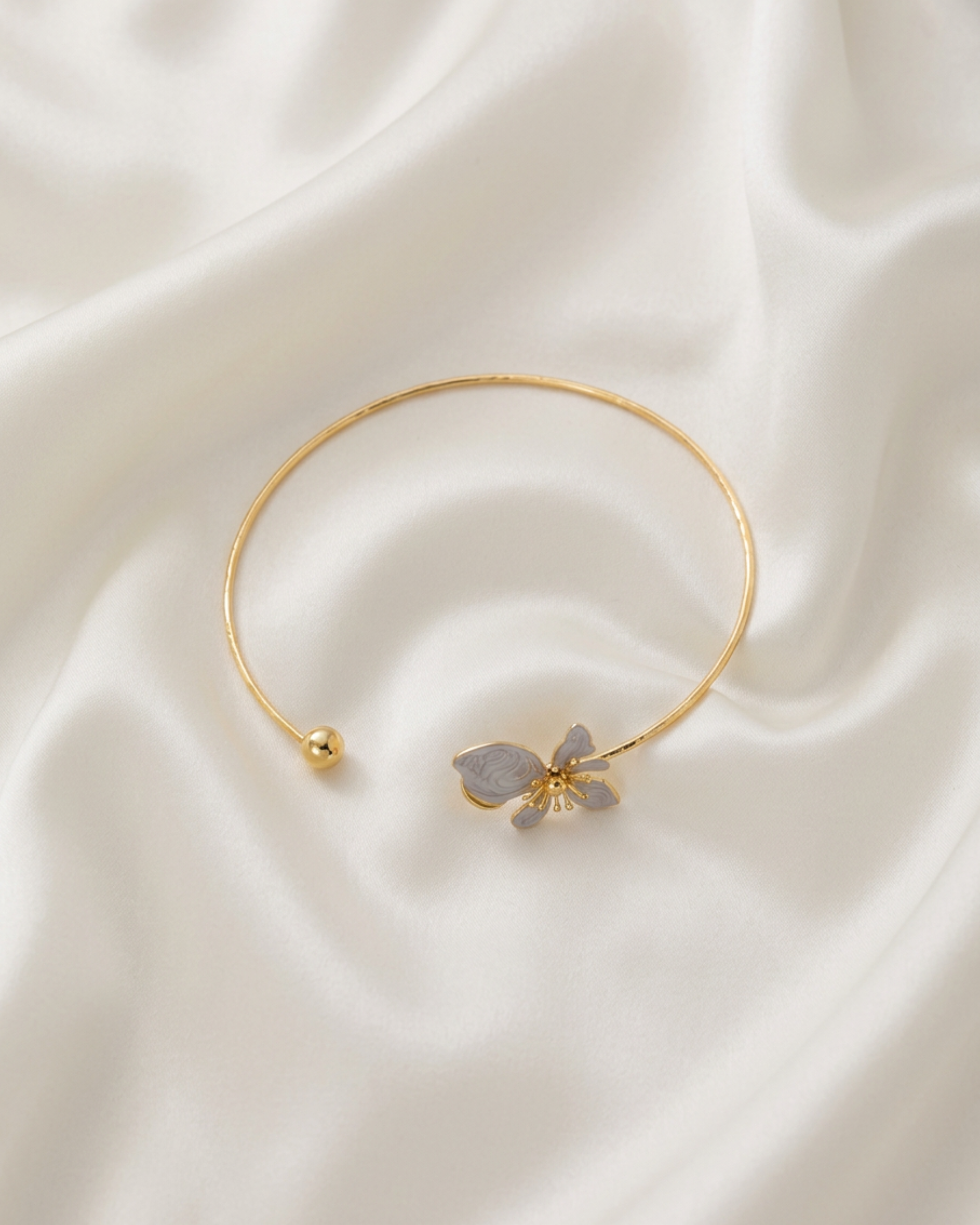 Trove Colombo Wisteria gold-tone iron choker necklace featuring a delicate grey floral charm